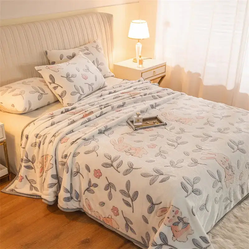 Soft cream-colored double sided plaid fleece blanket featuring pink and gray cartoon bunnies and leaves for bedroom softness