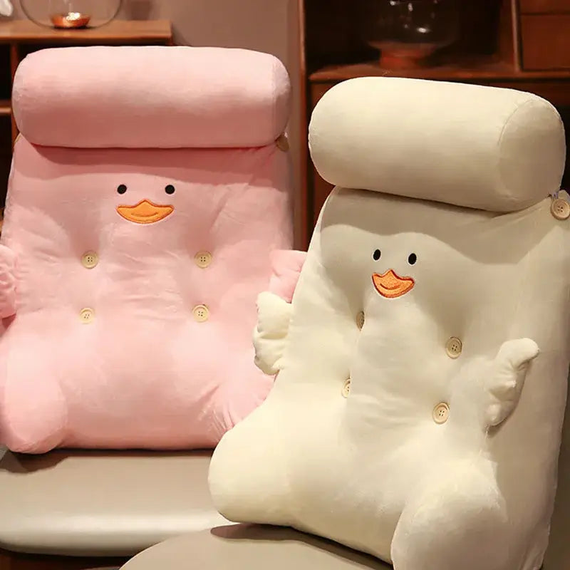 Pink and white plush dumb duck square back cushion with embroidered beak and button details for bedroom use