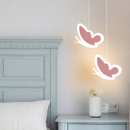 Two pink heart blossom butterfly led pendant lights with white outlines hang from the ceiling in bedroom chandelier