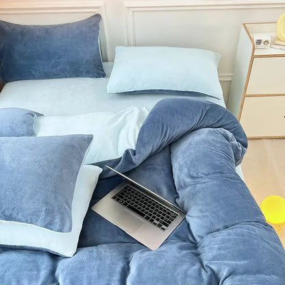 Soft blue milk velvet bedding set with duvet cover and pillows featuring a silver laptop in a winter bedroom