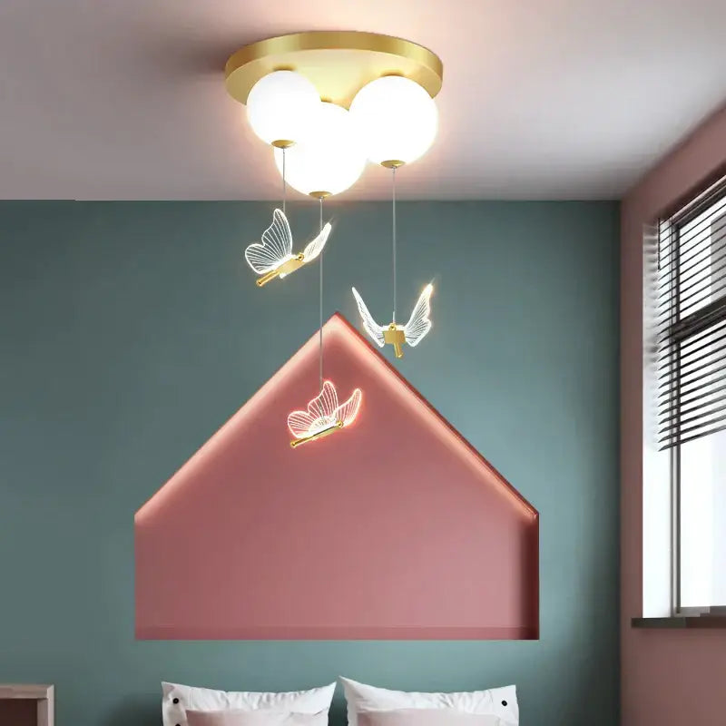 Gold-toned butterfly ball ceiling lamp with frosted globe bulbs and pink and white led butterfly accents for decorbites butterfly ball decor