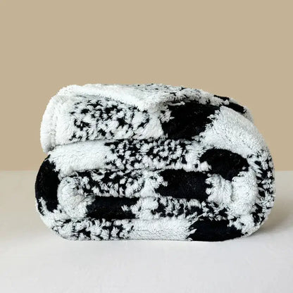 A plush black and white decorbites cationic jacquard blanket with soft fuzzy texture for cozy bedroom decor
