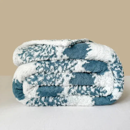A cozy teal and white plush decorbites cationic jacquard blanket with soft textured pattern for bedroom decor