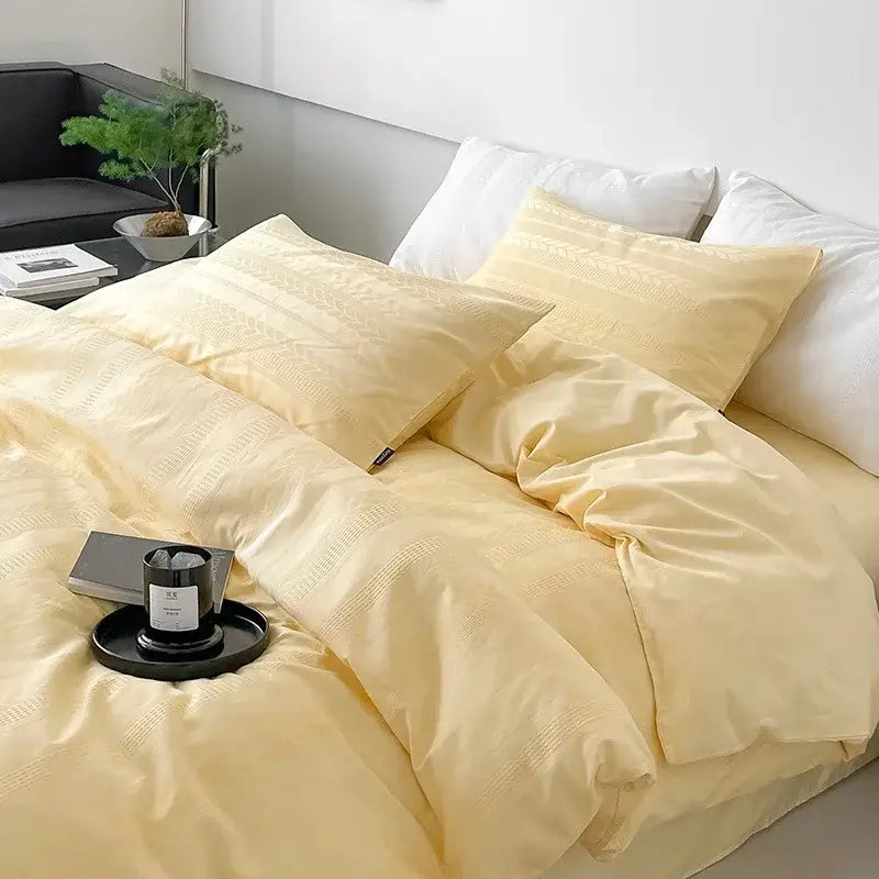 Cream-colored satin-like bedding set with subtle woven texture and matching pillowcases for decorbites cotton jacquard bedroom decor