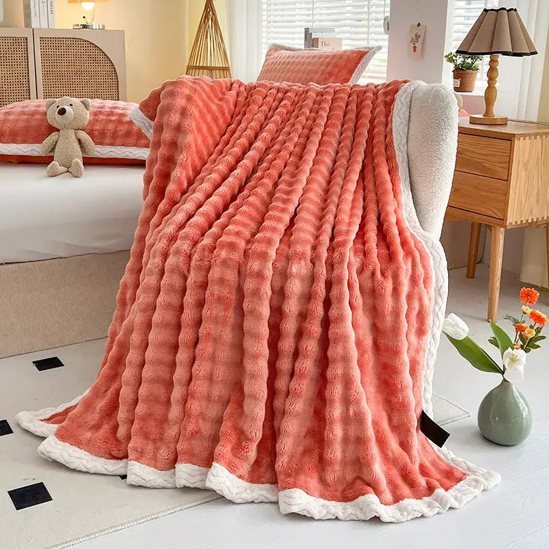 Coral-colored plush throw blanket with textured ribbed surface and white fleece lining cozy faux rabbit fur decorbites cozy faux