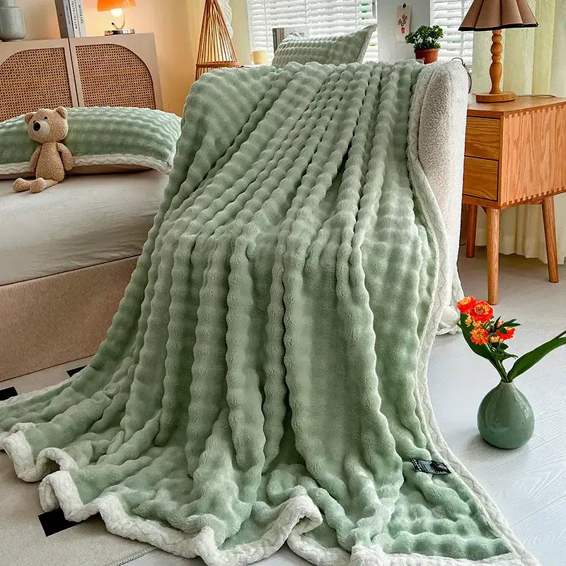 Soft mint green plush throw blanket with ribbed texture and white fleece trim from decorbites cozy faux rabbit fur collection