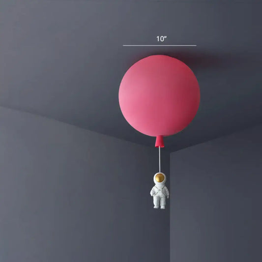 Pink astronaut ceiling lamp featuring a balloon-shaped acrylic pendant light with a small astronaut figurine for kids bedroom