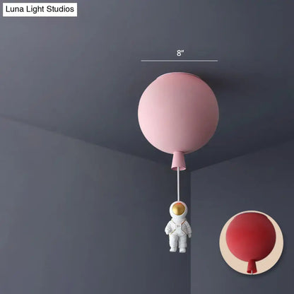 Pink astronaut ceiling lamp with acrylic pendant light shaped like a balloon and white astronaut figurine for kids bedroom