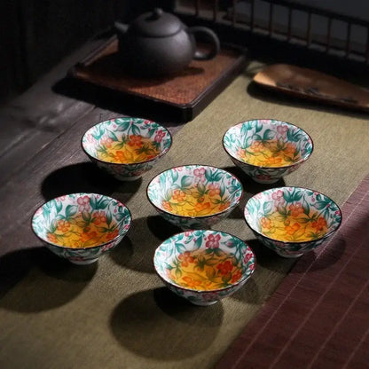 Six white porcelain hand-painted tea cups with vibrant pink, orange, and green floral patterns for decorbites blue dining set
