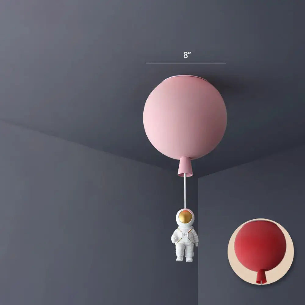 Pink balloon-shaped astronaut ceiling lamp with white astronaut figurine hanging below for bedroom pendant light