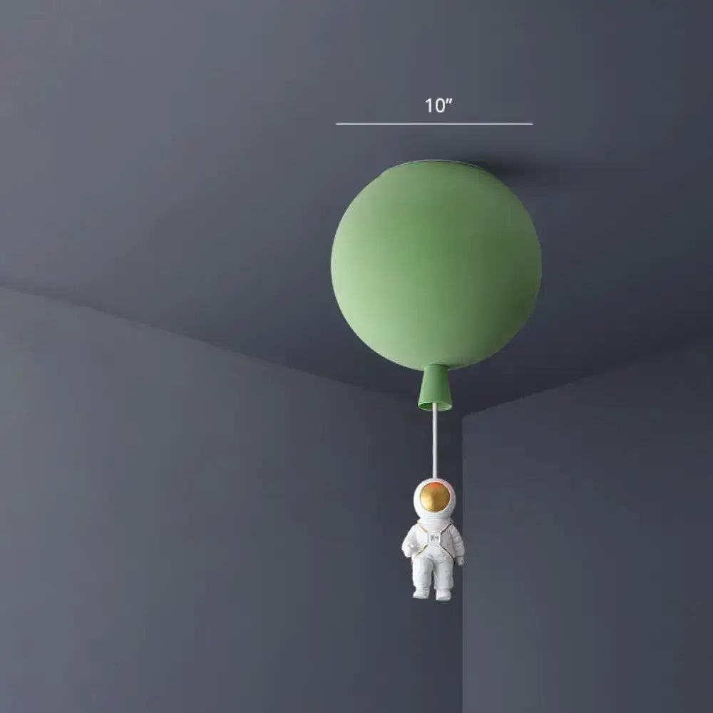 Matte sage green balloon-shaped ceiling lamp with a dangling astronaut figurine pink and blue astronaut ceiling lamp