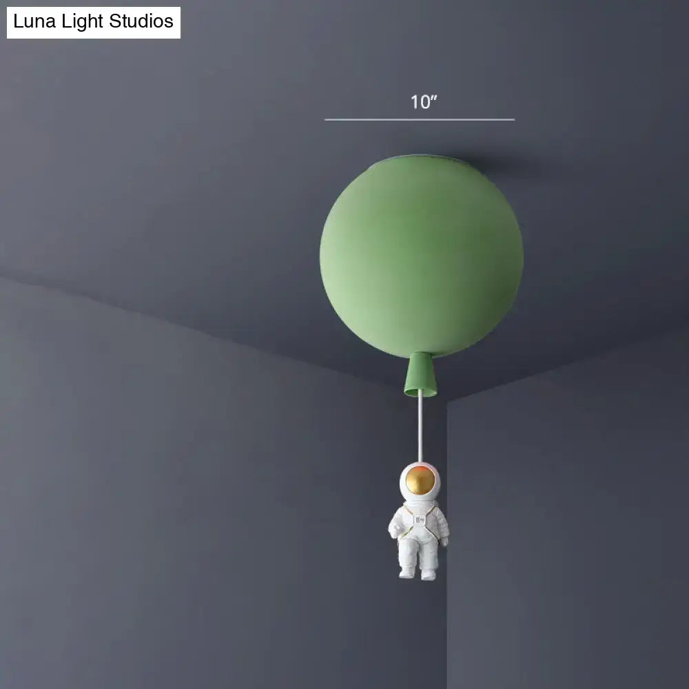 Whimsical green balloon-shaped ceiling lamp with a white astronaut figurine for a bedroom astronaut ceiling lamp