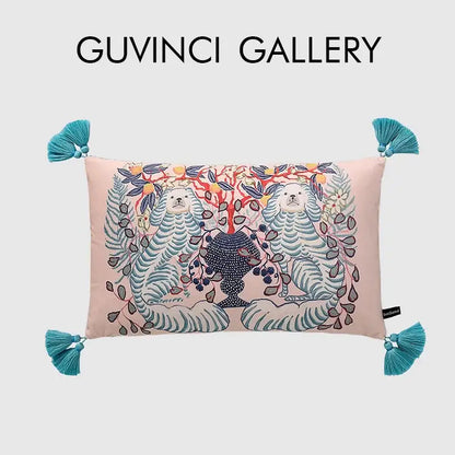 Pink rectangular lumbar pillow cover with embroidered white lion dog and blue lion vase design with teal tassels