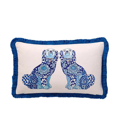 Cream-colored rectangular lumbar pillow cover with blue fringed edges and embroidered blue lion dog design for bedroom decor