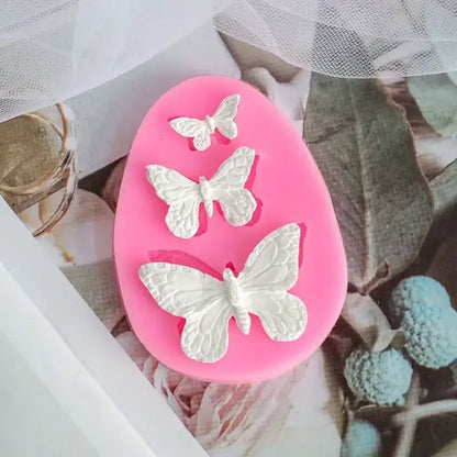 Pink butterfly silicone fondant mold with three white butterfly designs for cake decorating by decorbites