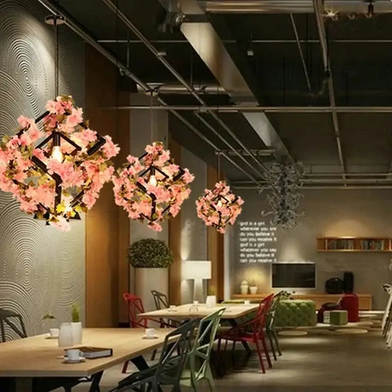 Pink cherry blossoms pendant lights with black geometric frames featuring decorbites green plants for dining room decor