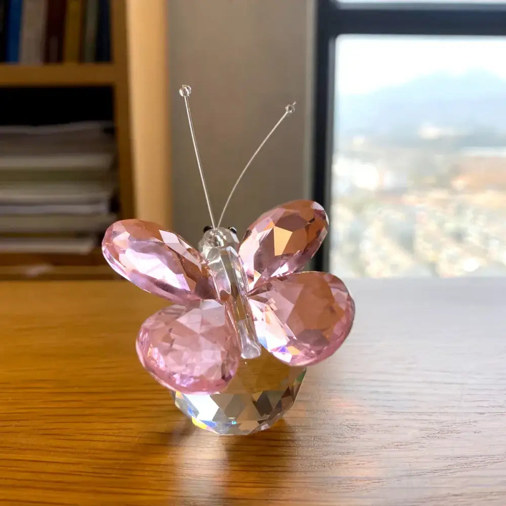 Pink and clear crystal butterfly figurine with faceted wings and metallic antennae for bedroom decor by decorbites