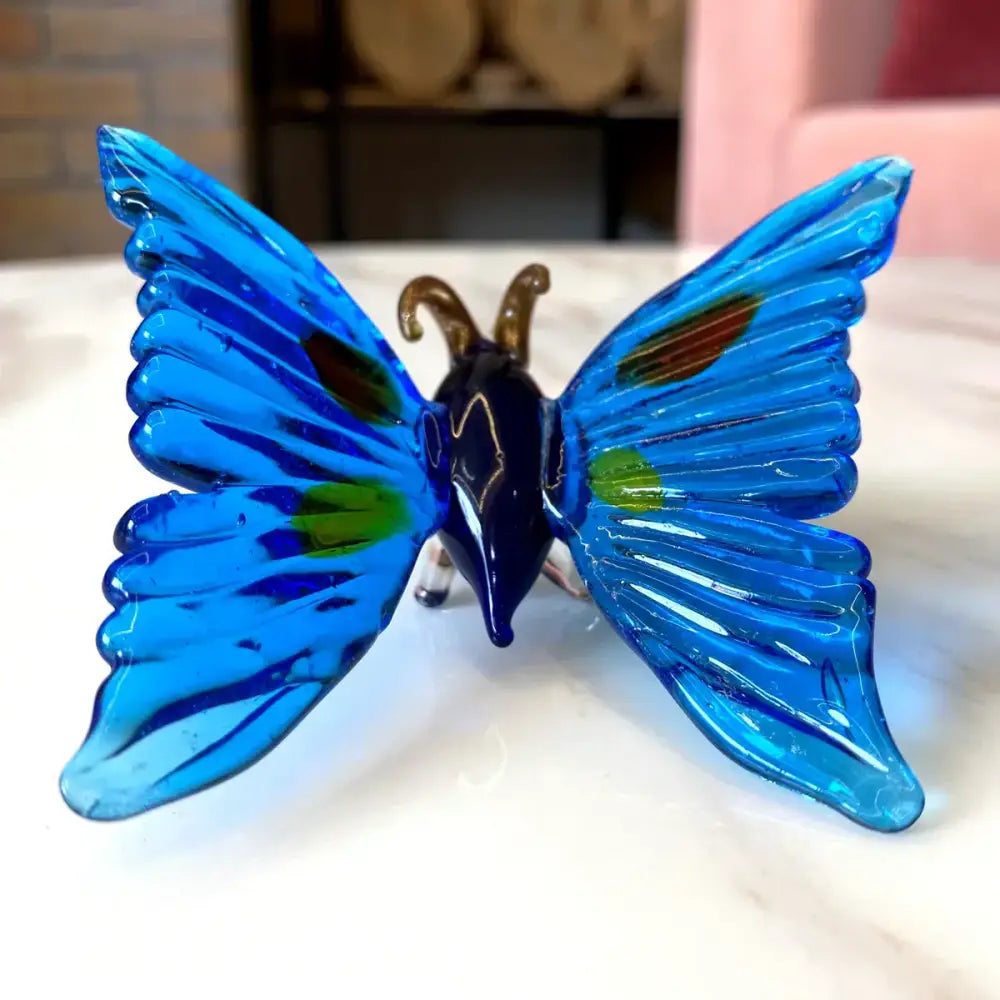 Vibrant blue glass crystal butterfly figurine with iridescent green and gold accents for bedroom decorbites decor
