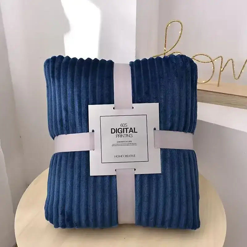 Deep blue corduroy throw blanket neatly folded with white ribbon complements decorbites cozy striped flannel fleece