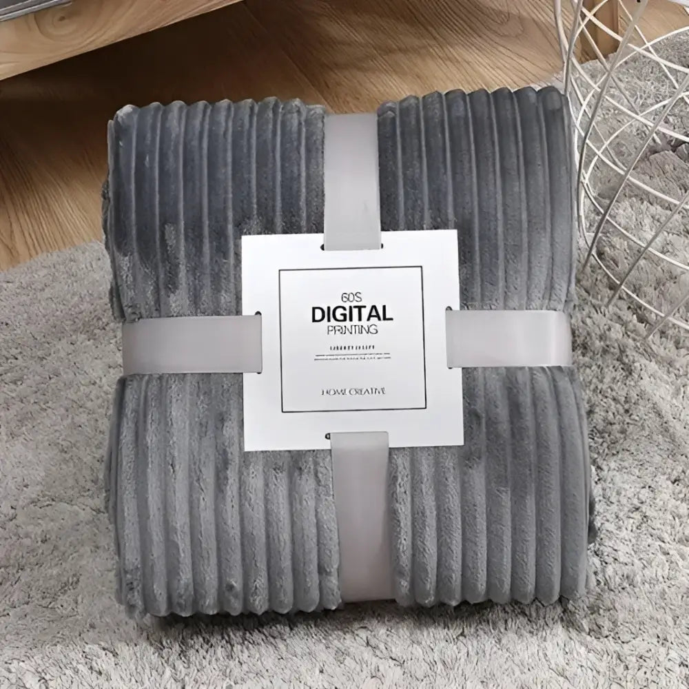 Gray corduroy throw blanket with plush texture and vertical ribbed pattern complementing decorbites cozy striped flannel fleece