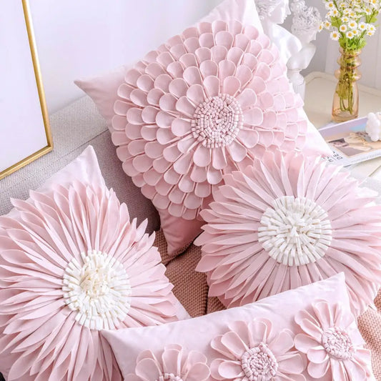 Pink floral throw pillows with layered petals and white embroidered centers on a plush pillowcase decorbites daisy sunflower