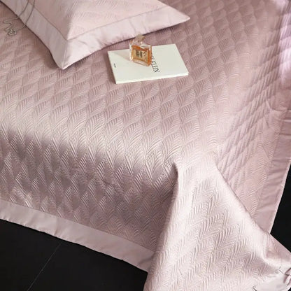 Soft pink quilted bedspread set with subtle feather pattern and satin trim made from decorbites cool lyocell fiber