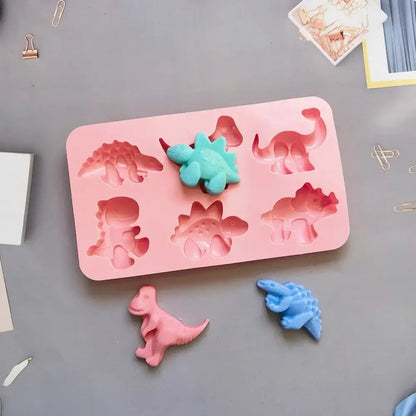 Pink dino silicone cake mold with teal and blue molded dinosaurs for kitchen baking silicone cake mold tray