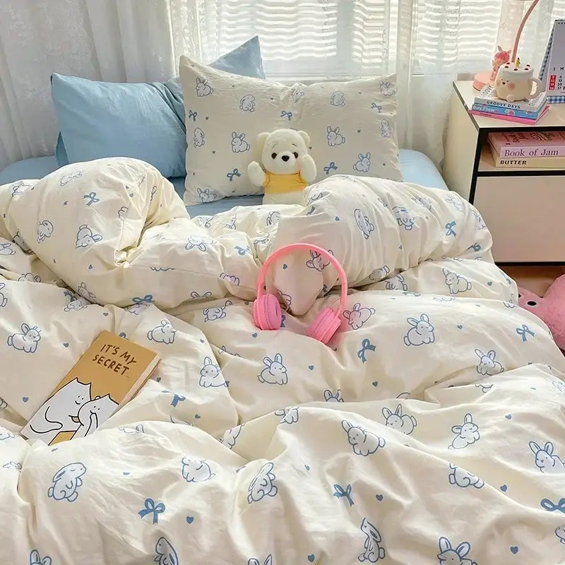 Cream-colored cotton comforter set with cozy cartoon printed blue bunnies and bows for decorbites bedroom decor