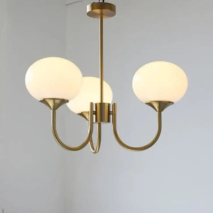 Brass-finished three-light designer loft pendant with frosted pink glass globe shades for bedroom decorbites pendant lights