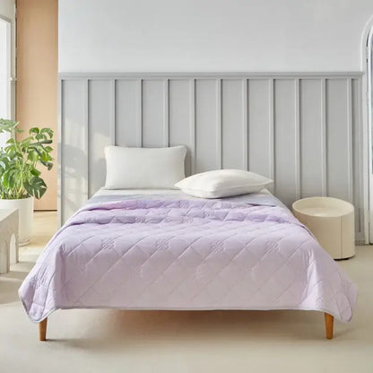 Lavender quilted cool summer blanket with subtle floral embroidery and diamond-stitched pattern for bedroom comfort