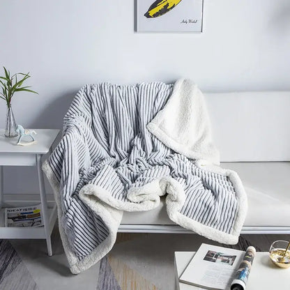 Gray corduroy throw blanket with plush white fleece lining from decorbites cozy nordic wool collection for bedroom use