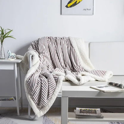 A plush taupe throw blanket with ribbed texture and soft white sherpa lining from decorbites cozy nordic wool collection