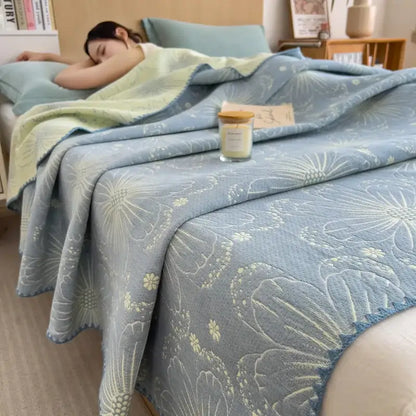 Light blue quilted decorbites cotton towel blanket with embroidered floral patterns in pale green and white for bedroom use