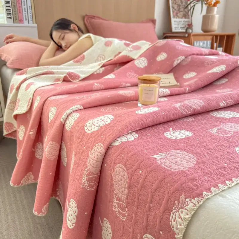 Pink strawberry-patterned quilted cotton towel blanket with white lace trim from decorbites cotton towel collection