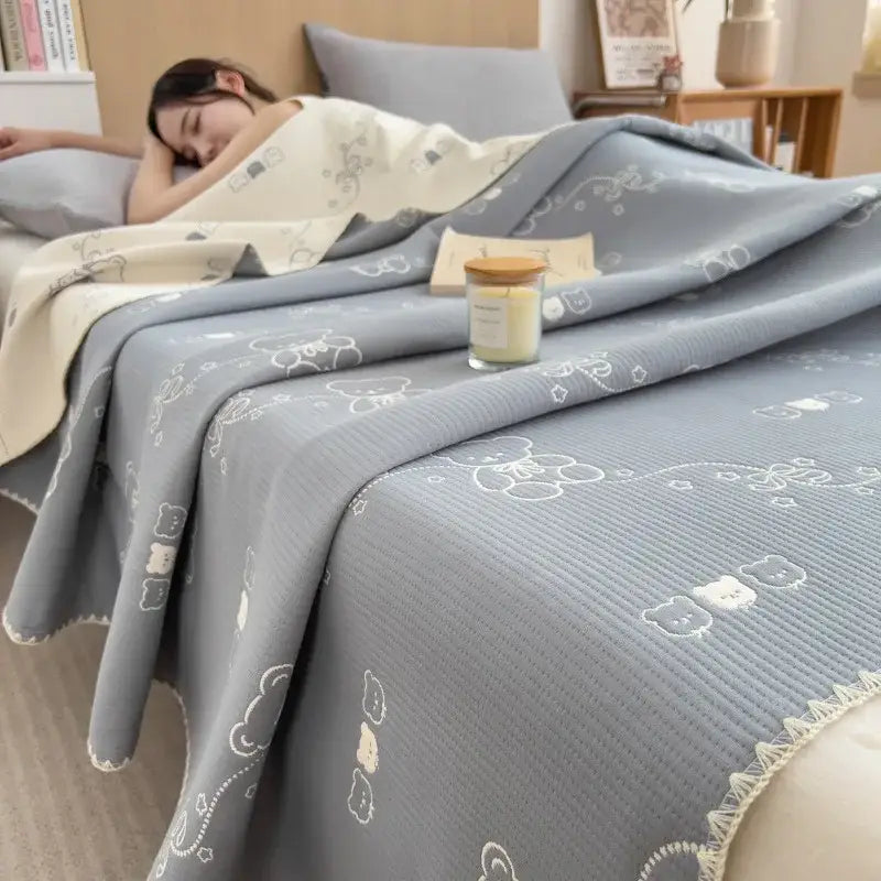 Gray quilted cotton towel blanket with embroidered white bear and cloud patterns from decorbites cotton towel collection