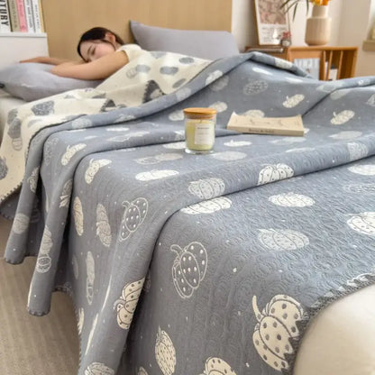 Gray quilted cotton towel blanket with white and cream pumpkin pattern from decorbites cotton towel collection