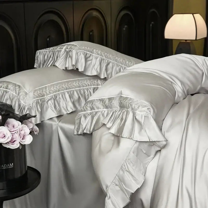 Silver satin pillowcases with delicate lace trim and ruffled edges from decorbites 1000tc luxury embroidery bedding set