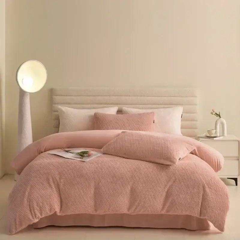 Pink textured winter fleece bedding set with duvet cover and matching pillows on a tufted headboard bed