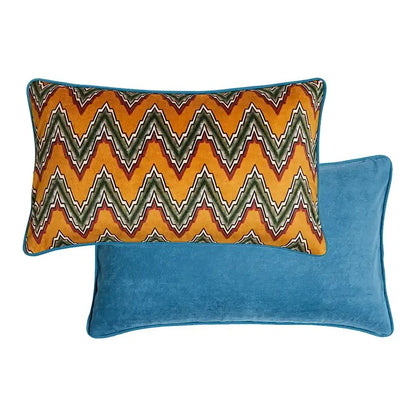Vibrant orange and green zigzag-patterned velvet cushion cover with teal border displayed on blue velvet cat print velvet cushion