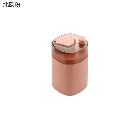Pink and translucent automatic toothpick dispenser holder in rose gold with a hexagonal lid and textured body dispenser holder
