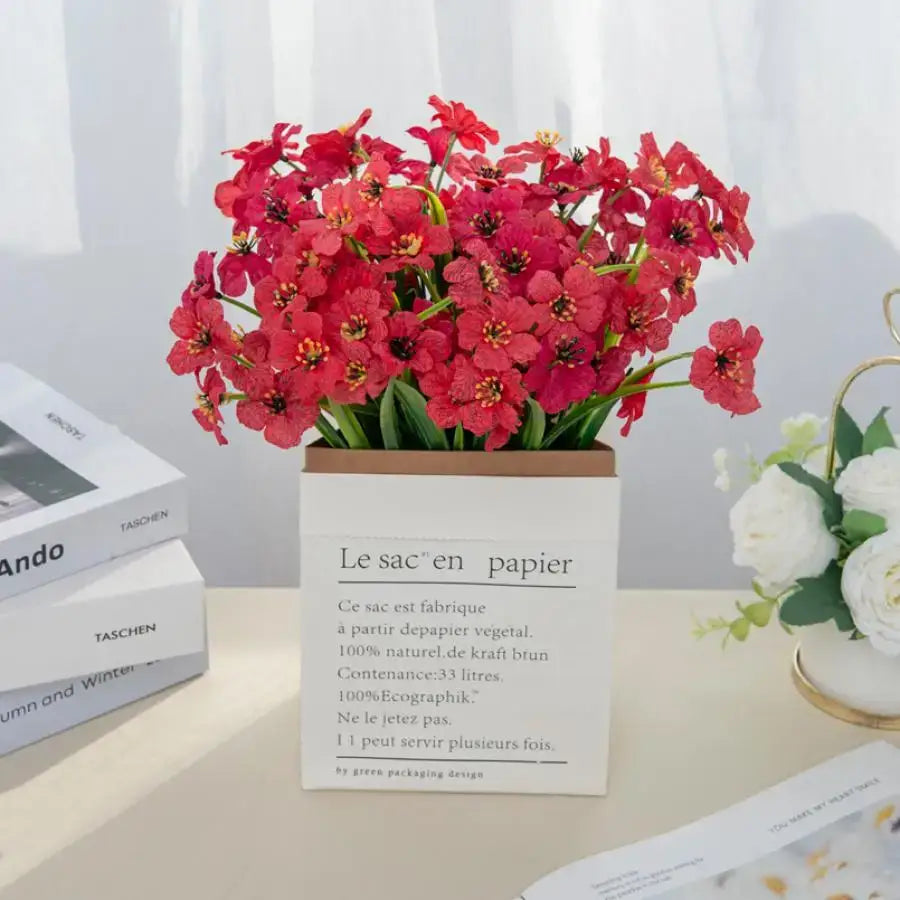 A vibrant artificial cherry bouquet with red and yellow blossoms in a white box for wedding decor or cherry blossom wall