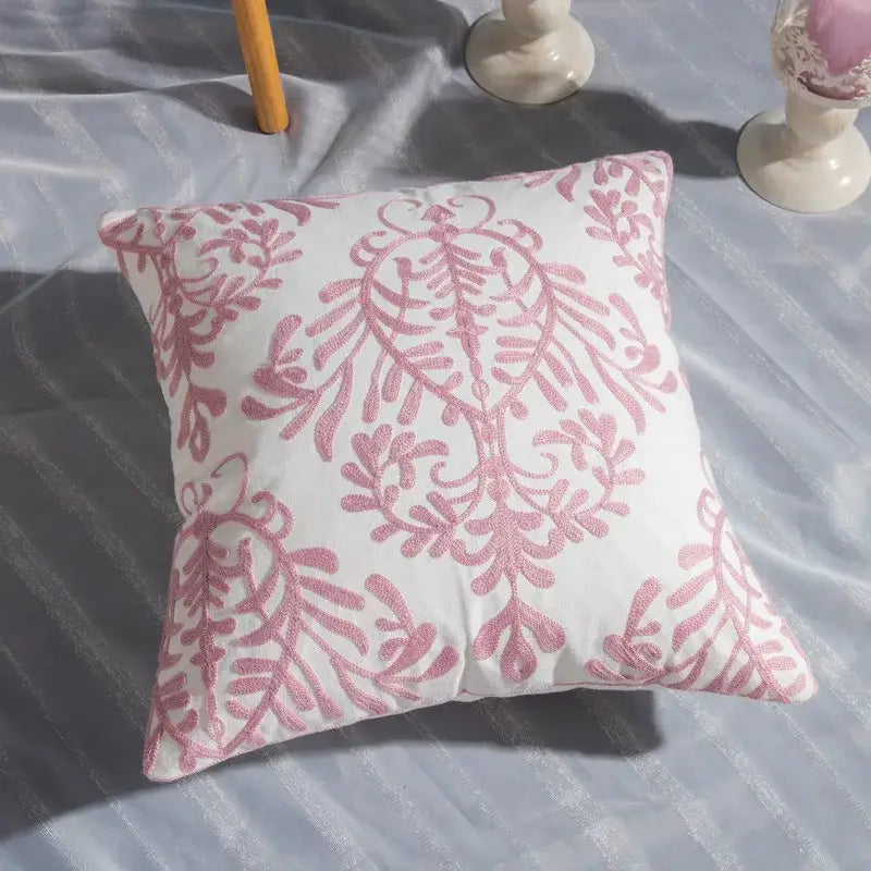A white cotton cushion with pink intricate cotton flower embroidered geometry pattern for living room decorbites cotton flower