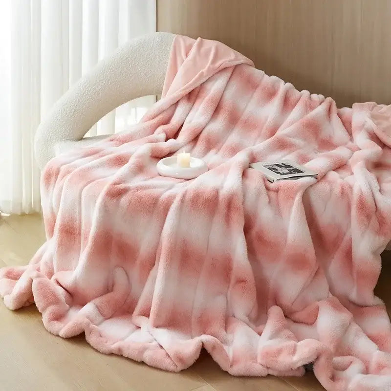 A plush pink and white tie-dye decorbites cozy fleece blanket with a soft fuzzy texture for bedroom use