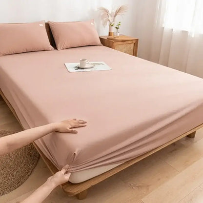 Soft blush pink decorbites cotton fitted sheet with smooth stretchy fabric draping elegantly over mattress