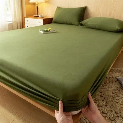 Olive green decorbites cotton fitted sheet and pillowcases with soft textured weave fitted on wooden bed frame