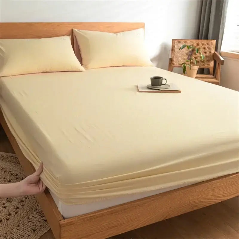 Cream-colored stretchy cotton fitted sheet with smooth texture and elastic edge for decorbites cotton fitted bedding