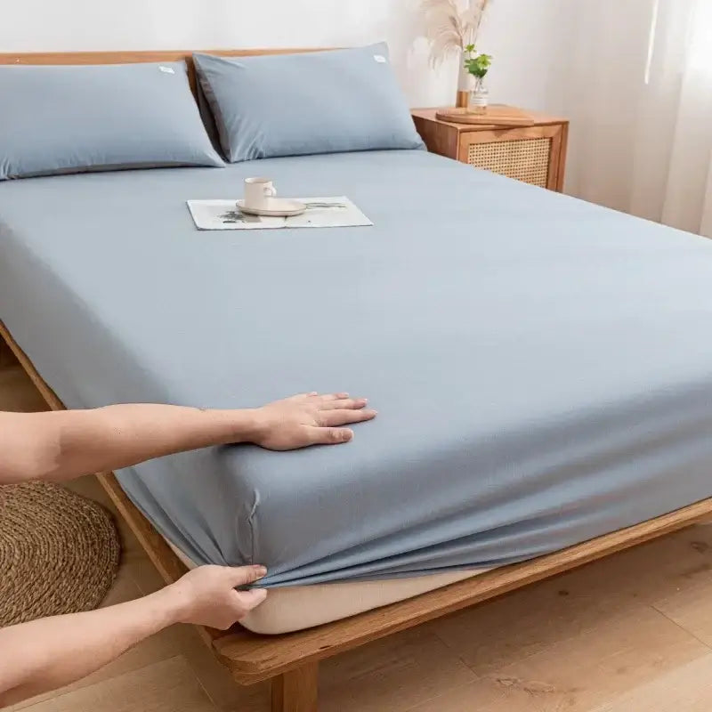 Light blue smooth textured cotton fitted sheet with matching pillowcases for soft decorbites bedroom use