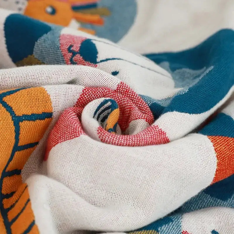 A soft white cotton lions bath towel with a playful colorful cartoon animal pattern for quick dry use