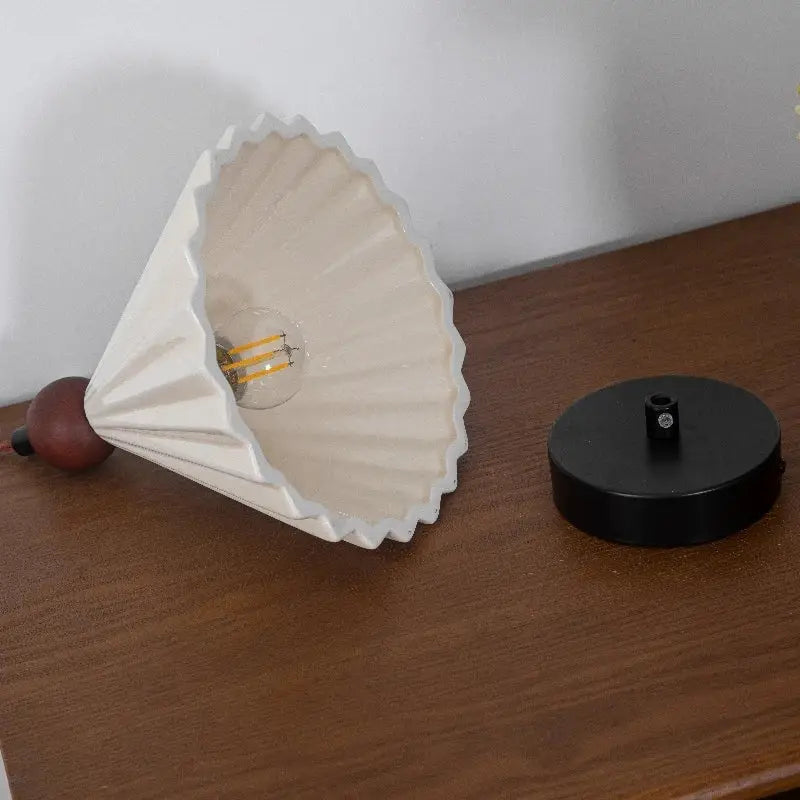 Cream-colored ceramic wood pendant light with pleated lampshade and exposed edison bulb for decorbites ceramic wood decor