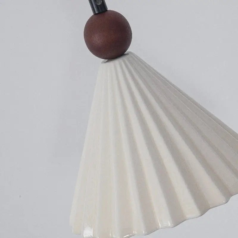 Cream-colored ceramic wood pendant light with fluted design and dark brown wooden sphere for bedroom decorbites decor